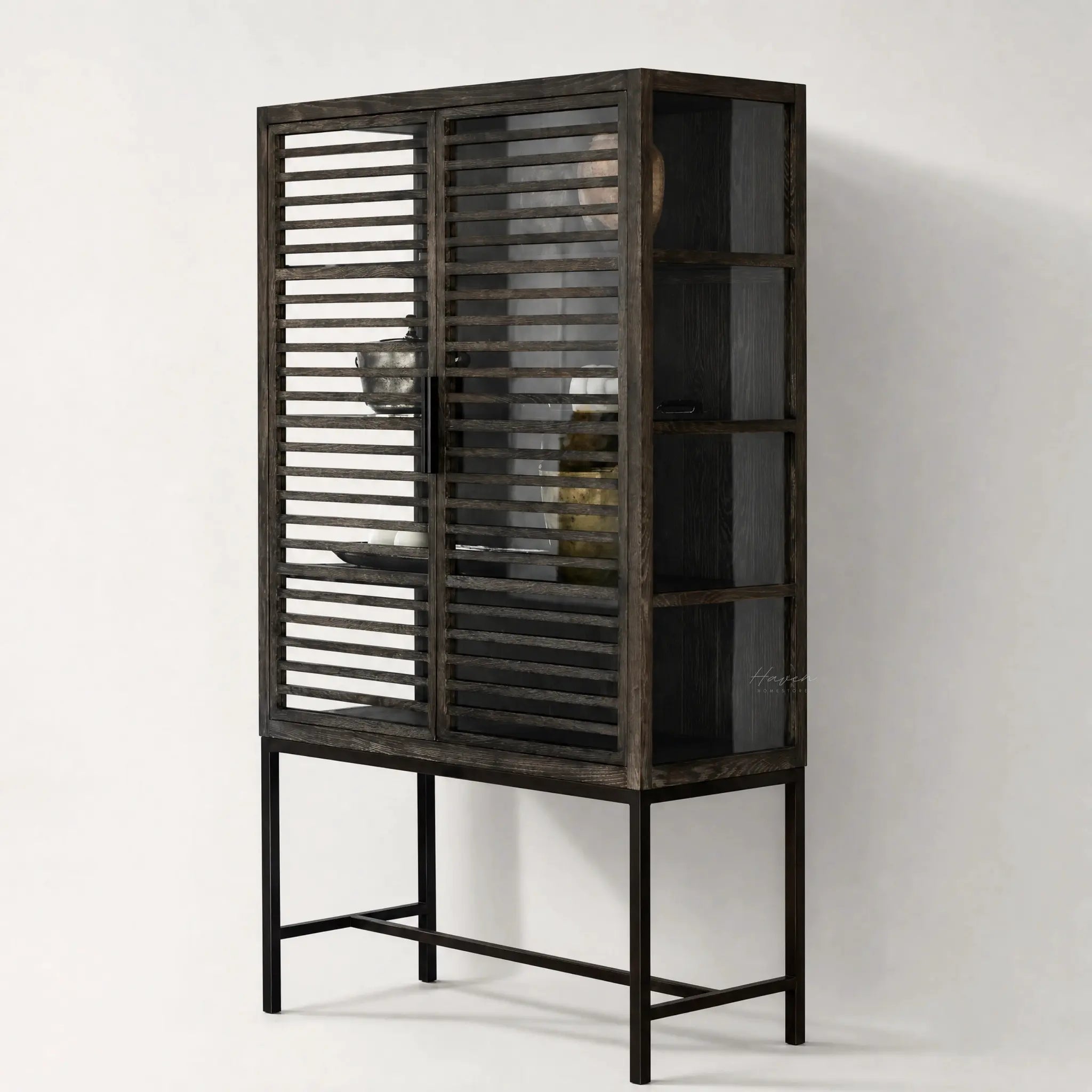 Kuro Slatted Cabinet in dark oak with glass behind slatted doors, warm, structured storage.