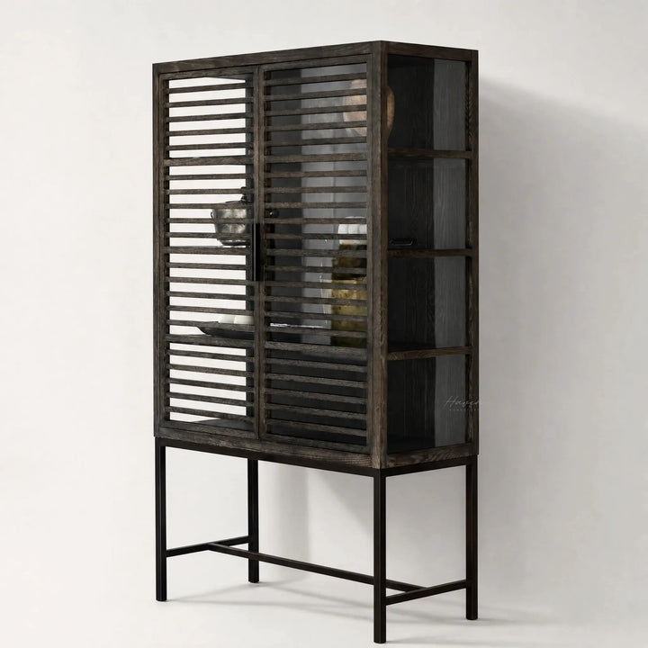 Kuro Slatted Cabinet in dark oak with glass behind slatted doors, warm, structured storage.