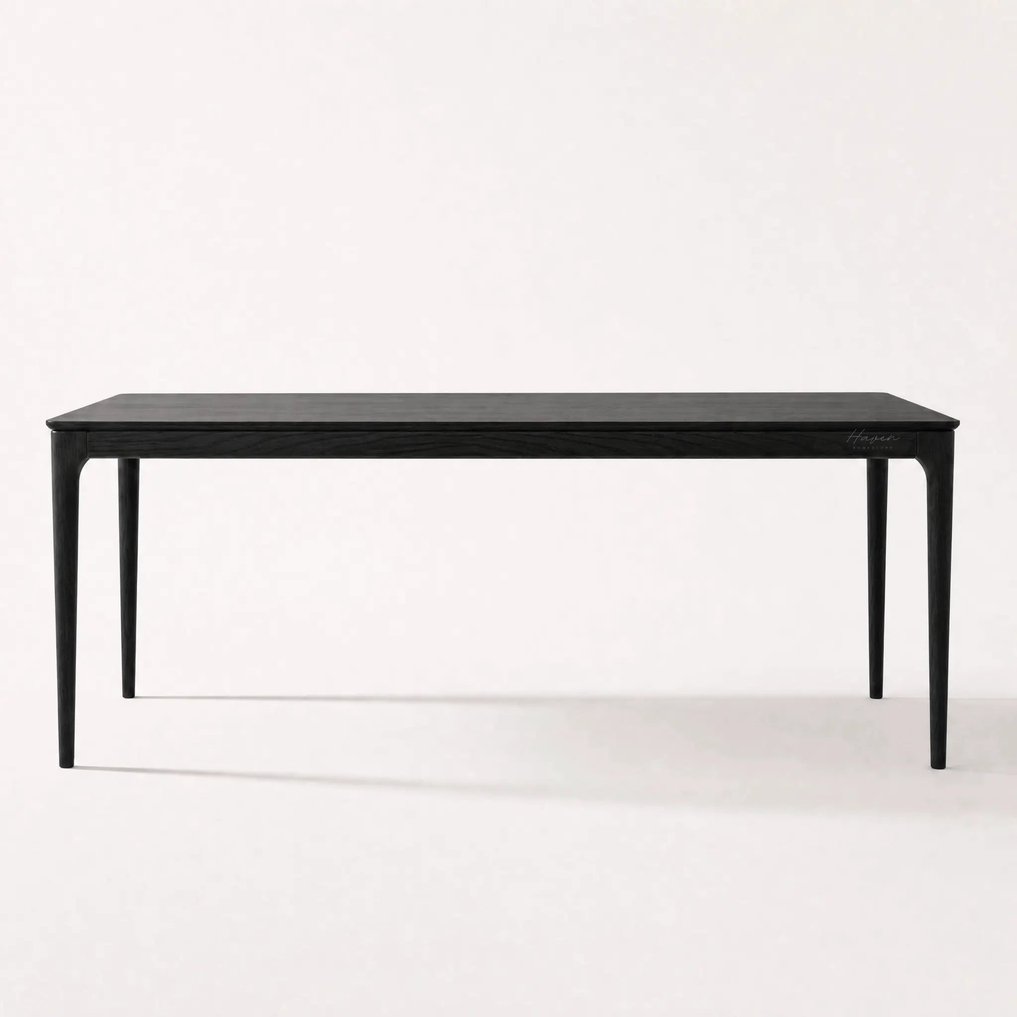 Baur Dining Table Black with solid North American ash, clean refined profile, natural grain visible.