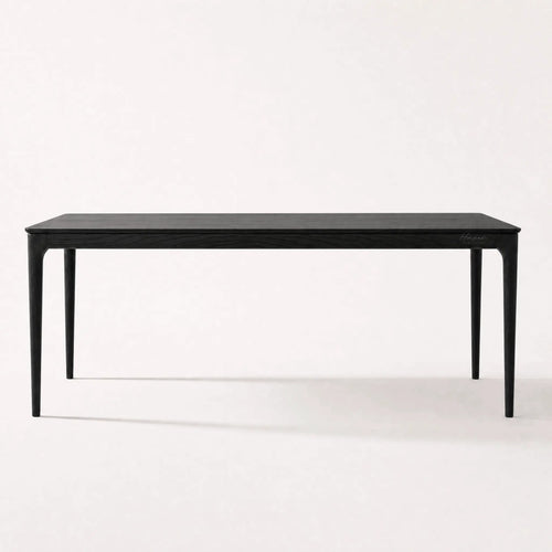 Baur Dining Table Black with solid North American ash, clean refined profile, natural grain visible.