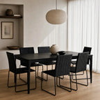 Baur Dining Table Black in a modern dining room with black chairs and beige walls.