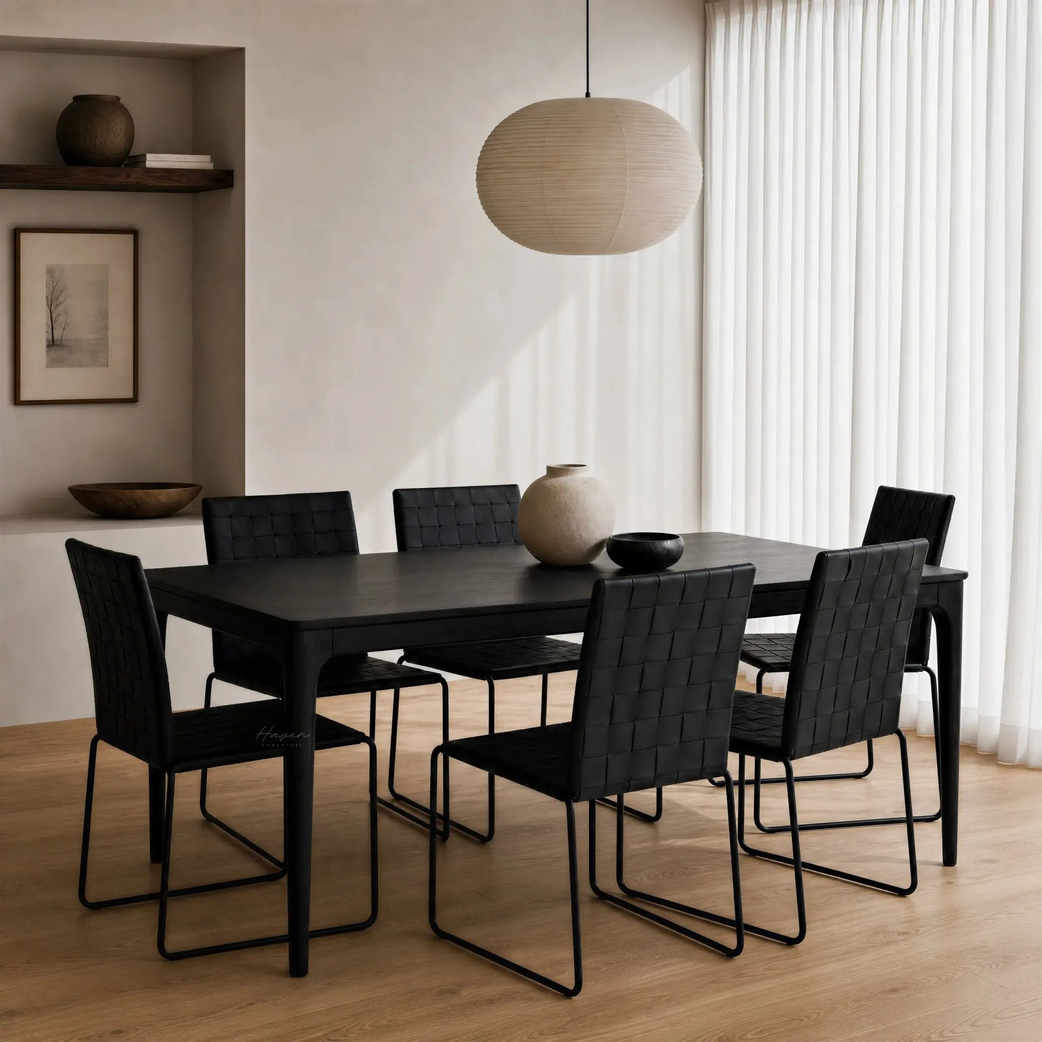Baur Dining Table Black in a modern dining room with black chairs and beige walls.