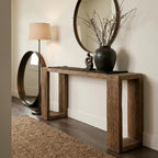 Casa Console in reclaimed elm with aged black wash, paired with a round mirror and twig vase in an entryway.