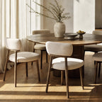 Maison Dining Chair with a solid ash frame and upholstered polyester seat and back, shown around a round wooden dining table.