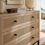 Cardrona 3 Drawer Commode with woven rattan fronts, timber frame, and slim black iron base.