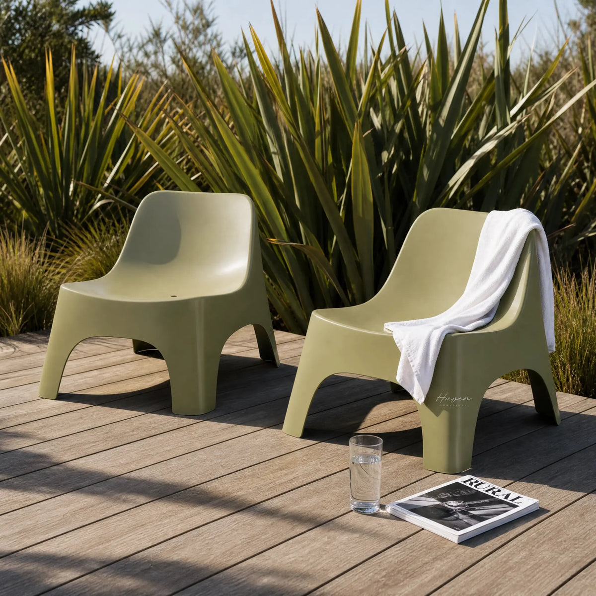 Two polypropylene Forma outdoor chairs on a wooden deck with tall plants; white towel draped over one.