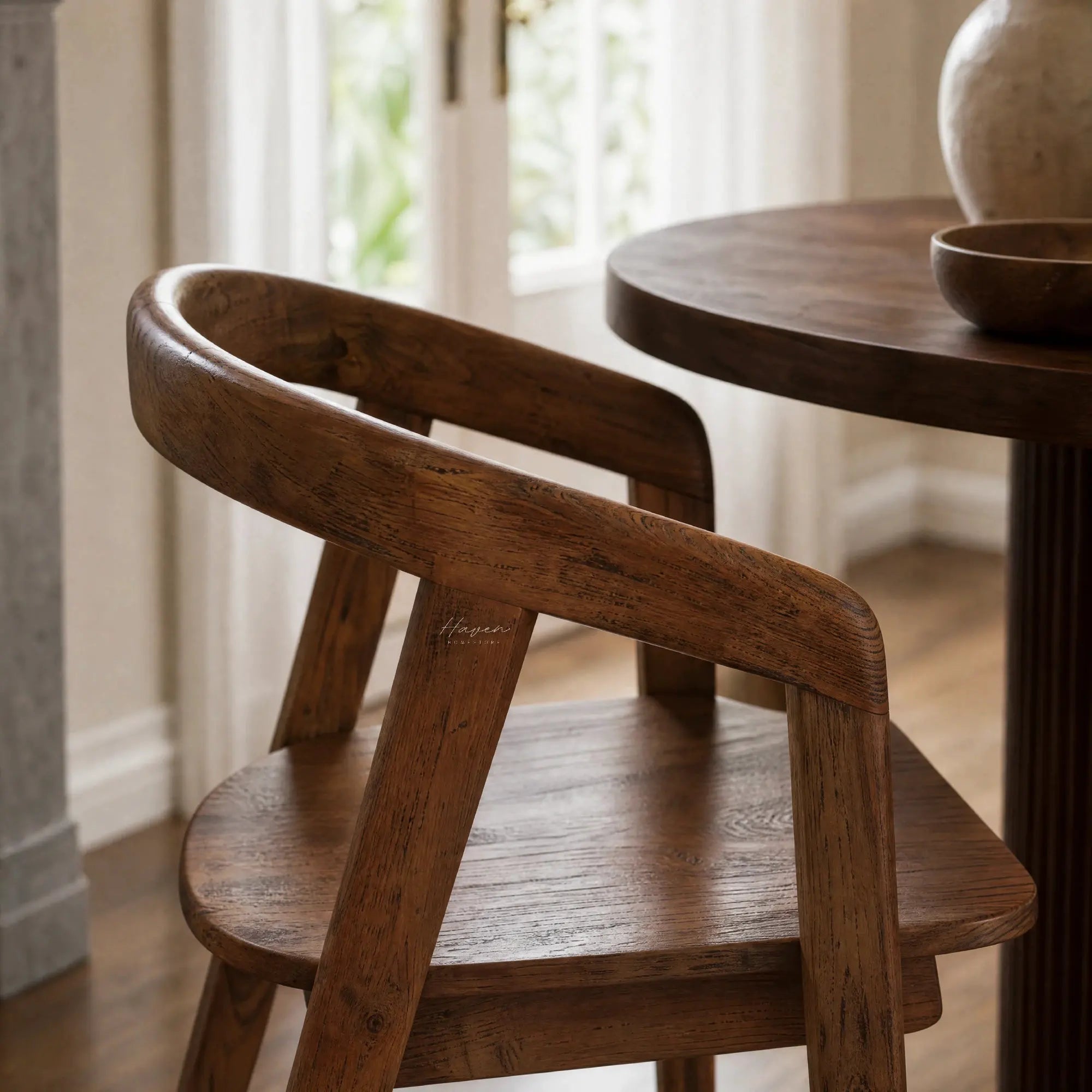 Dune Teak Dining Chair with sculptural form, curved arms, and warm solid teak.