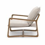 Solid oak lounge chair with stone-washed sand cushions. Coastal-style seating with a curved frame for a relaxing living space.