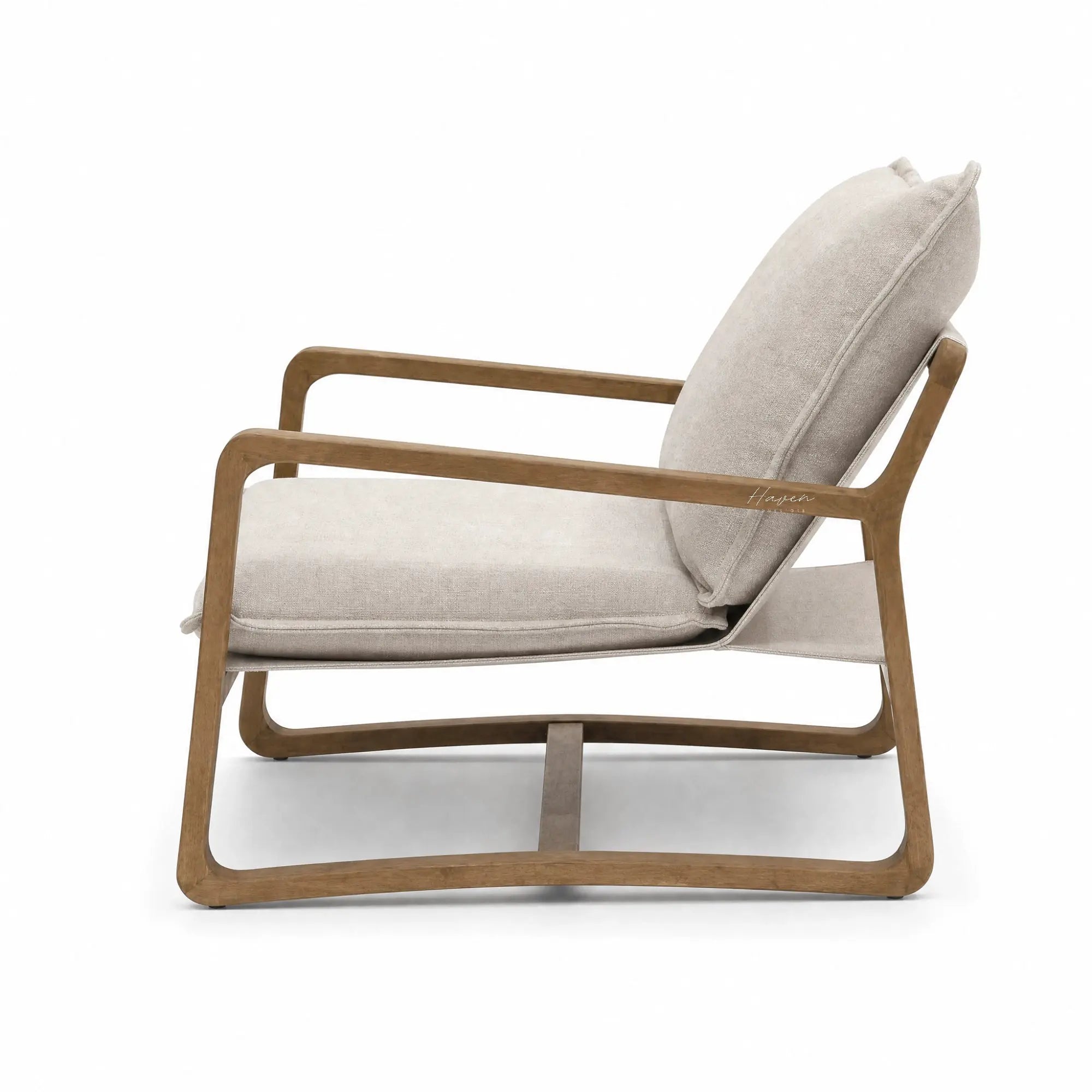 Solid oak lounge chair with stone-washed sand cushions. Coastal-style seating with a curved frame for a relaxing living space.