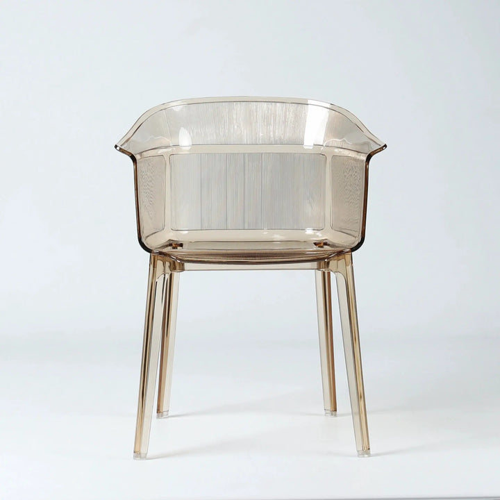 Translucent amber polycarbonate chair with sculptural wraparound silhouette and fine vertical texturing on back and seat.