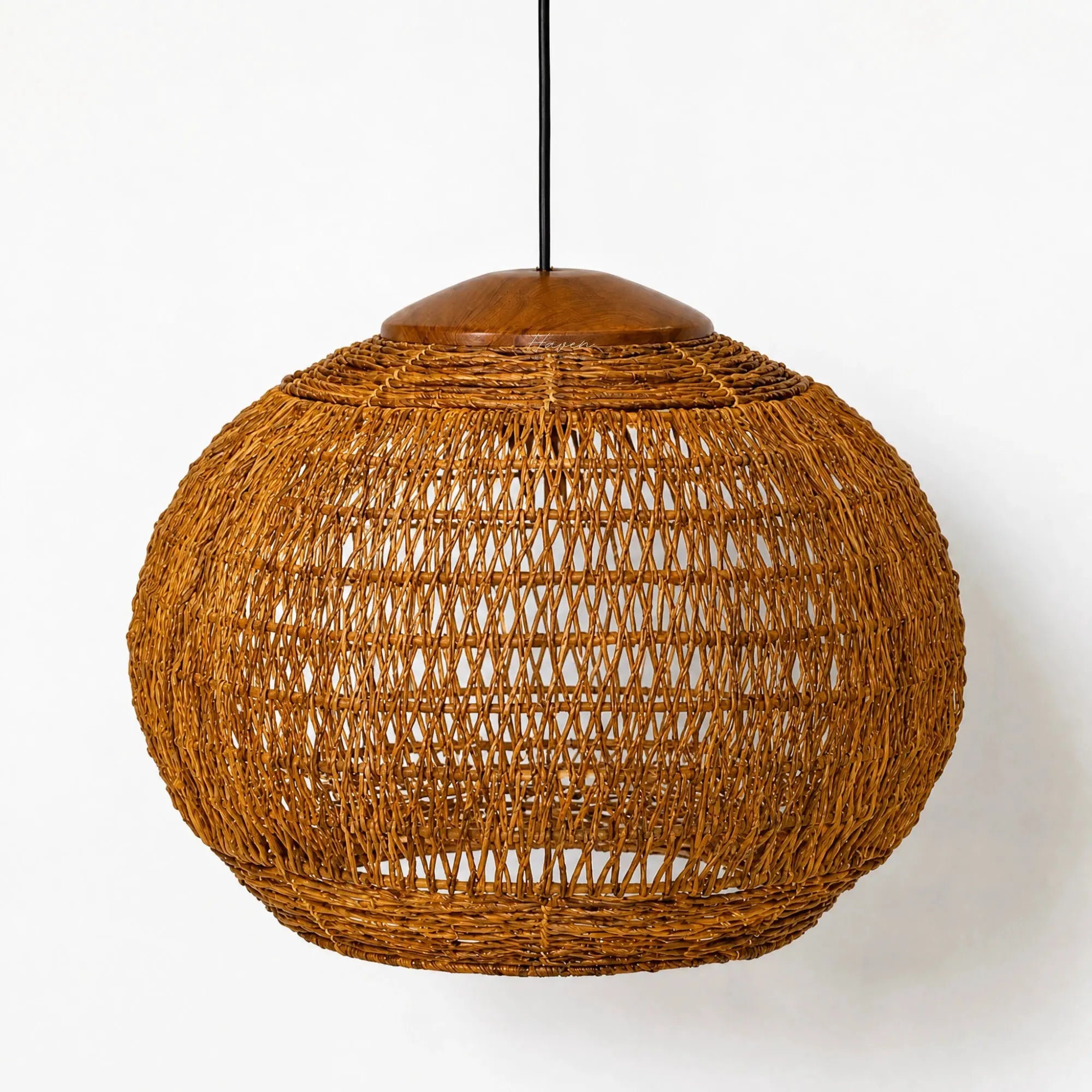 Round banana leaf pendant light with open woven texture and teak top detail, creating warm filtered ambiance.