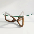 Maddox Mid Century Coffee Table with round glass top and sculptural ash base.