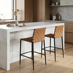 Calibri Counter Stool with a woven PU leather seat and slim powder-coated metal frame at a white marble kitchen island.