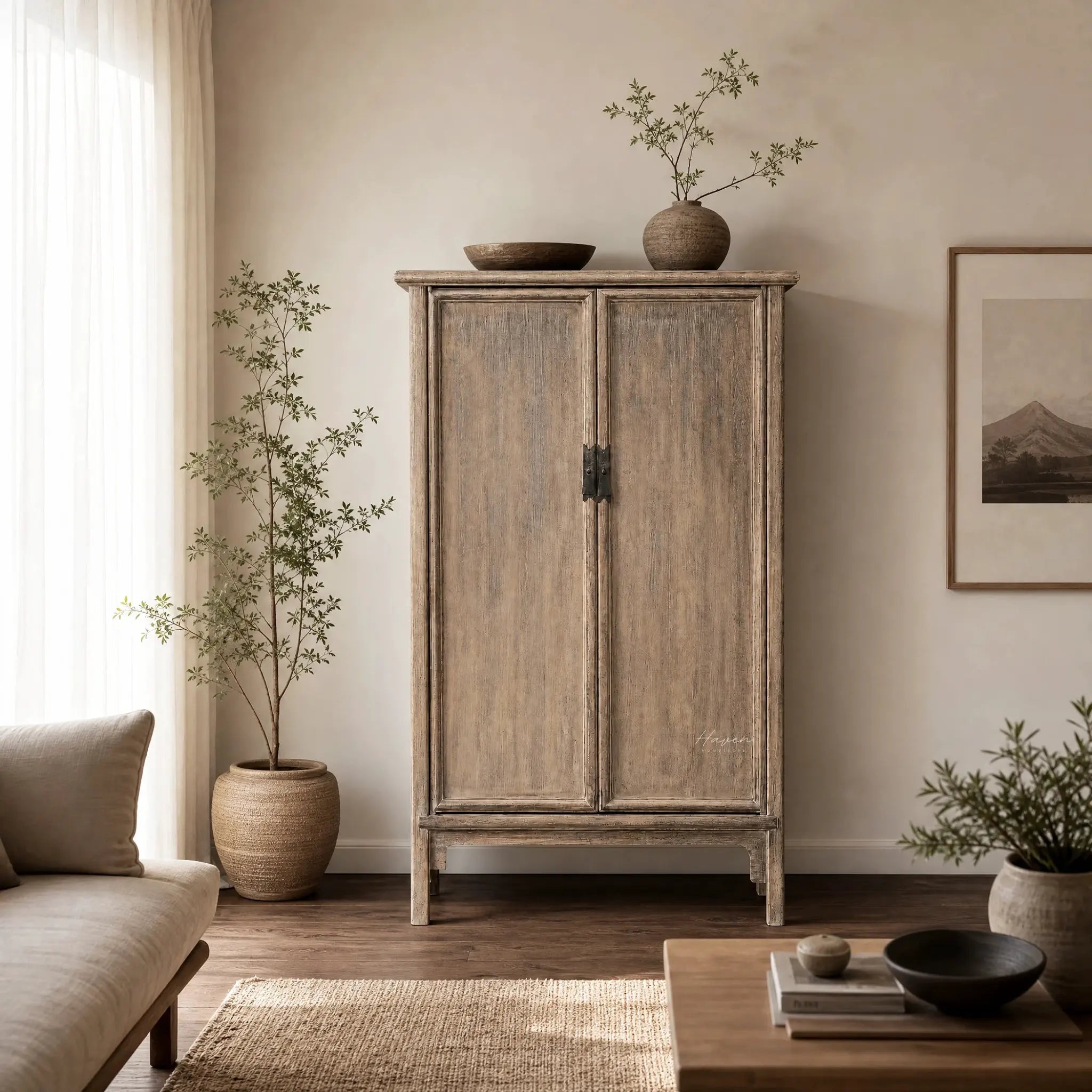 Lotus 2 Door Cabinet in weathered poplar with aged finish, topped by a vase and bowl in a warm living room.