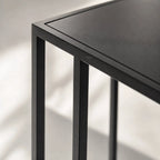 Cantilever Side Table - Min 2 in black iron with a clean cantilever design beside a sofa or bed.