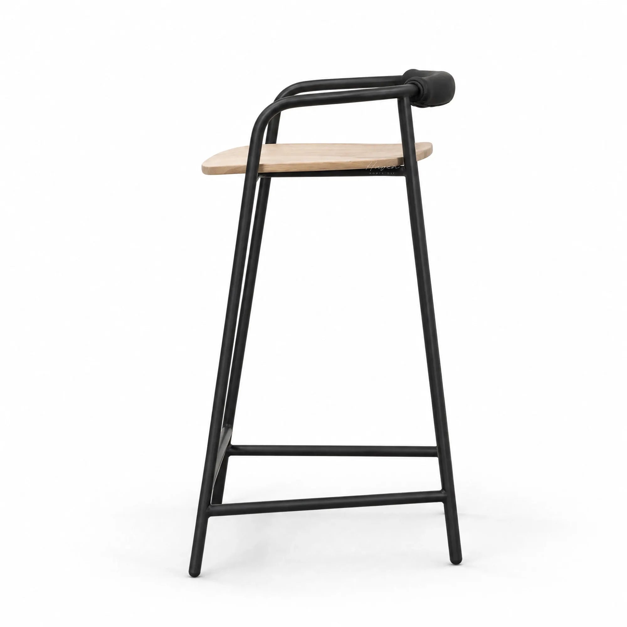 Black powder-coated iron counter stool with natural ash seat and padded leather backrest, minimalist Scandinavian design.