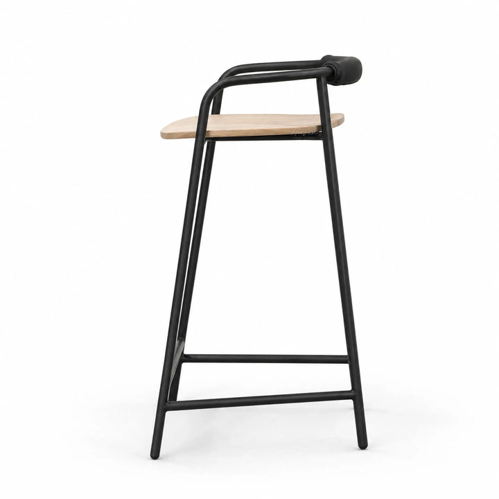 Black powder-coated iron counter stool with natural ash seat and padded leather backrest, minimalist Scandinavian design.