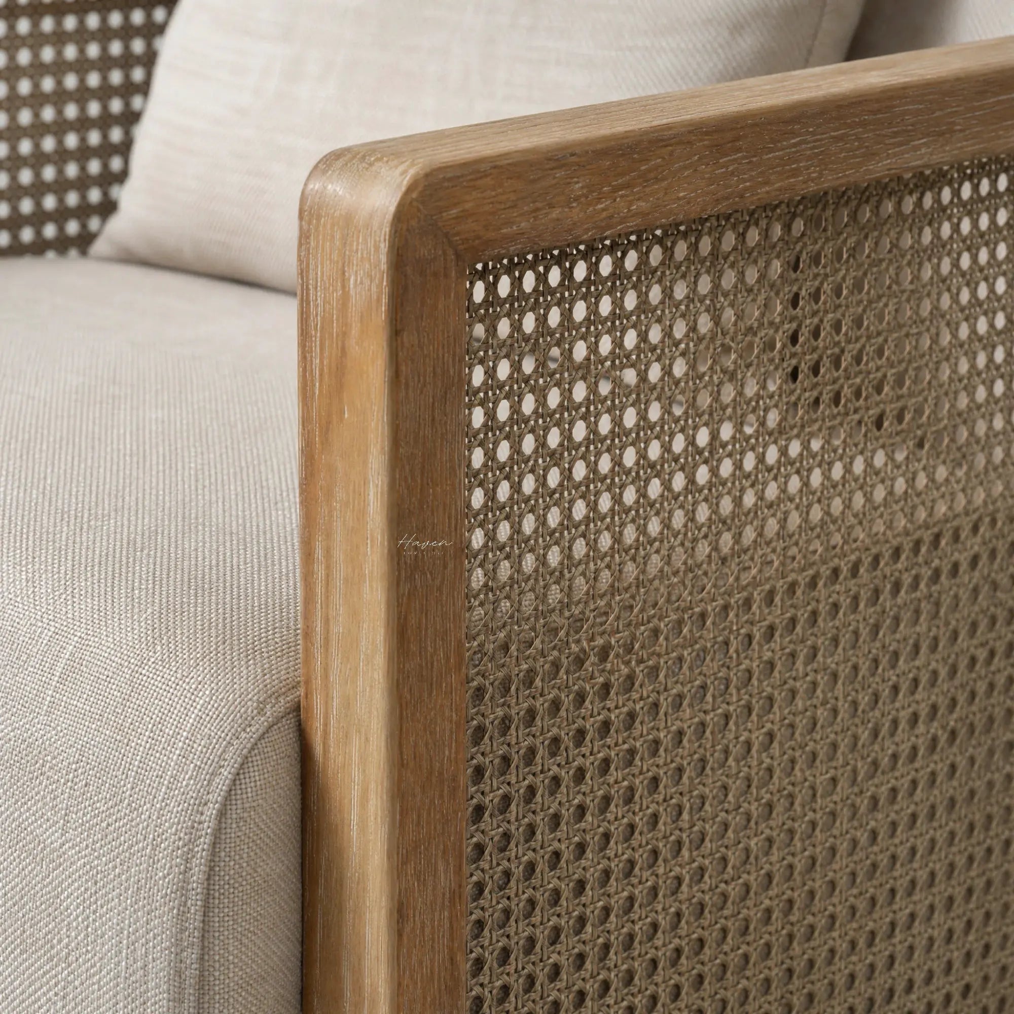 Solid ash wood frame and woven rattan panel detail on the Aro Swivel Armchair with soft linen-look upholstery.