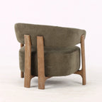 Back view of olive lounge chair with curved back, textured upholstery, and exposed ash wood frame.