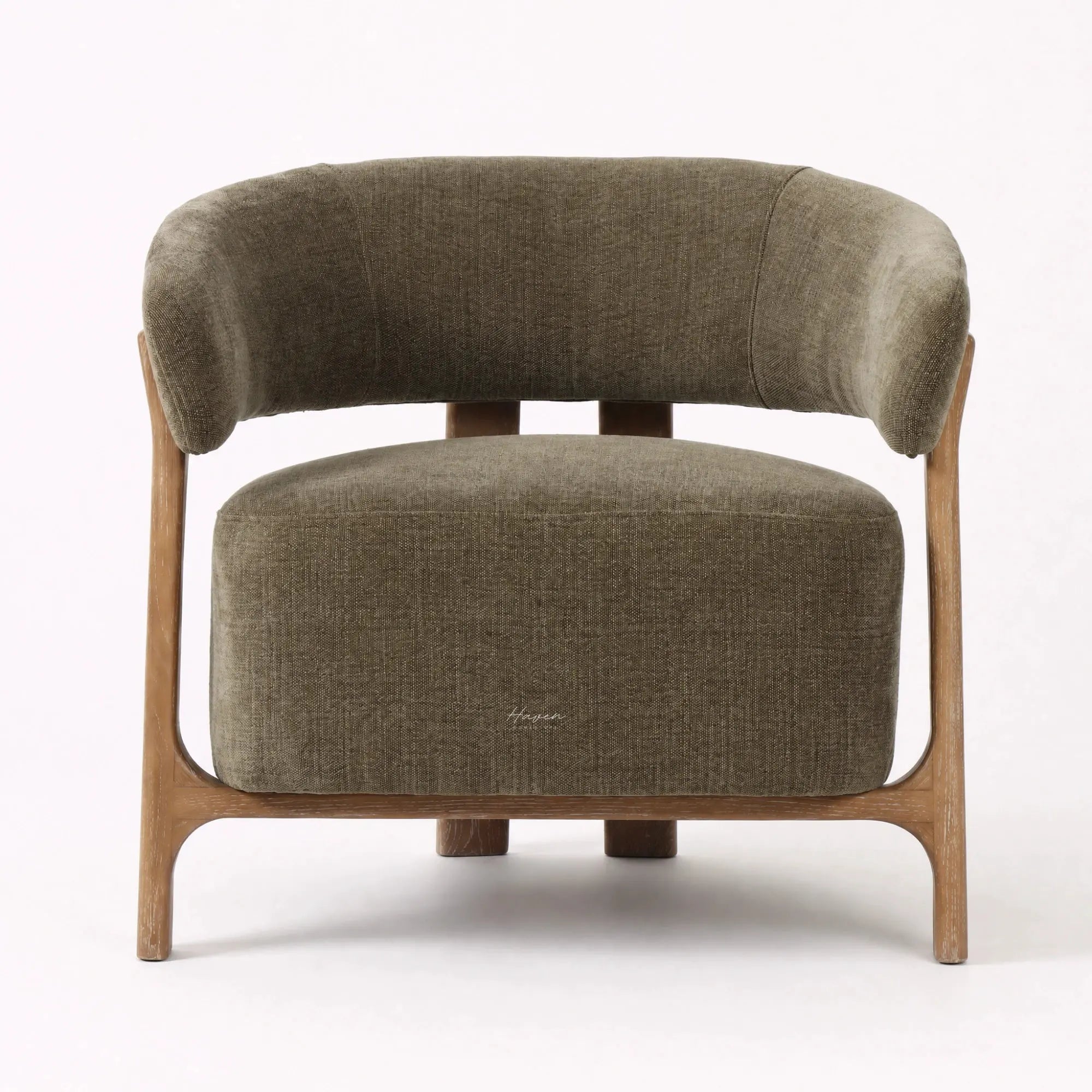 Curved olive lounge chair with textured neutral upholstery and exposed ash wood frame.