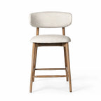 Aren counter stool with solid ash frame and soft beige polyester upholstery, offering relaxed comfort for kitchen or living spaces.