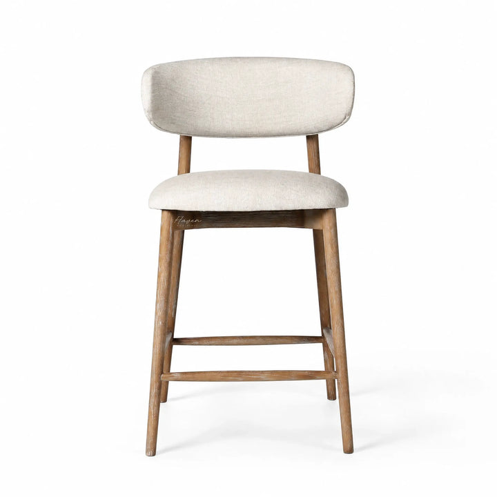 Aren counter stool with solid ash frame and soft beige polyester upholstery, offering relaxed comfort for kitchen or living spaces.