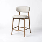 Aren counter stool with solid ash frame and beige polyester upholstery. Features a curved backrest and cushioned seat for kitchen comfort.