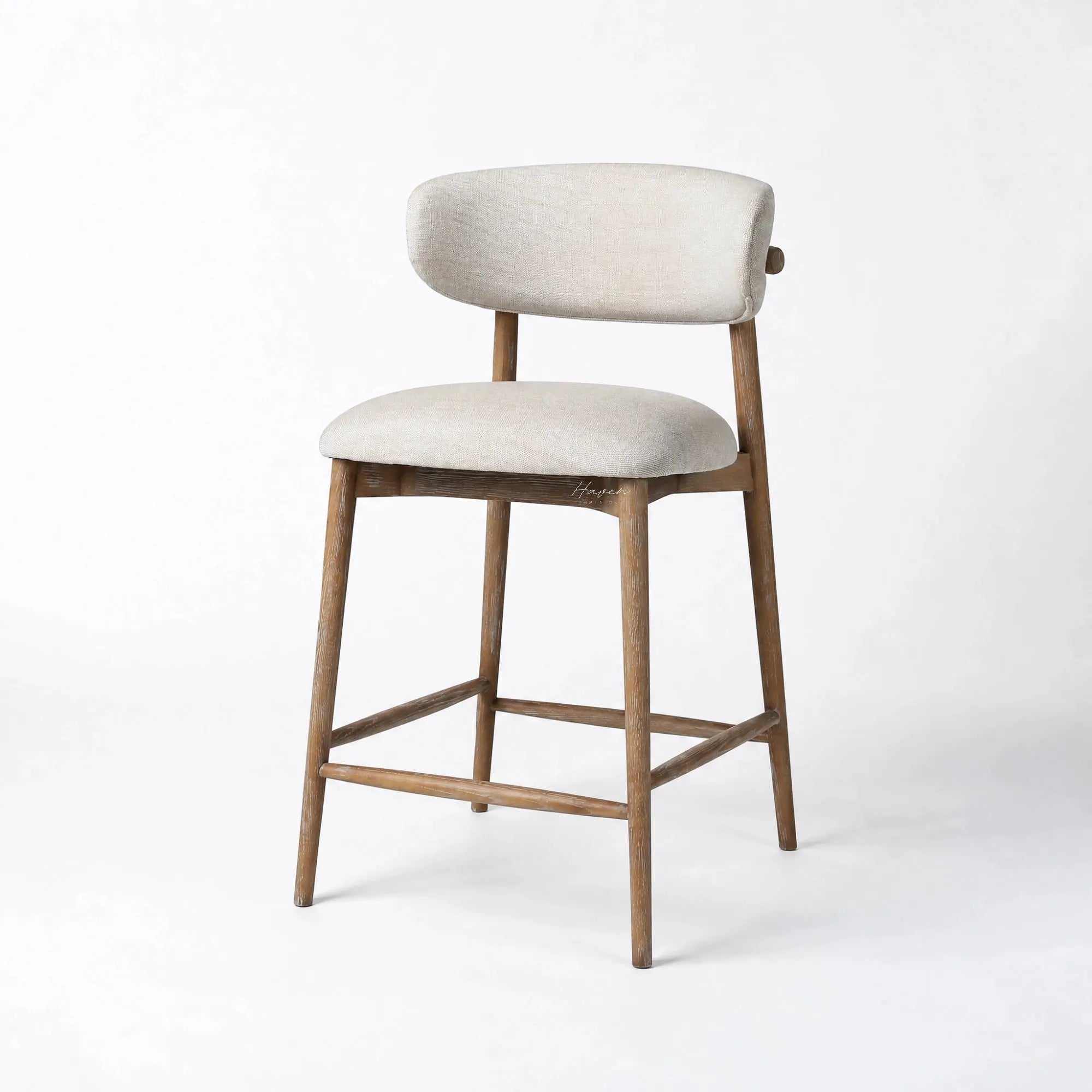 Aren counter stool with solid ash frame and beige polyester upholstery. Features a curved backrest and cushioned seat for kitchen comfort.