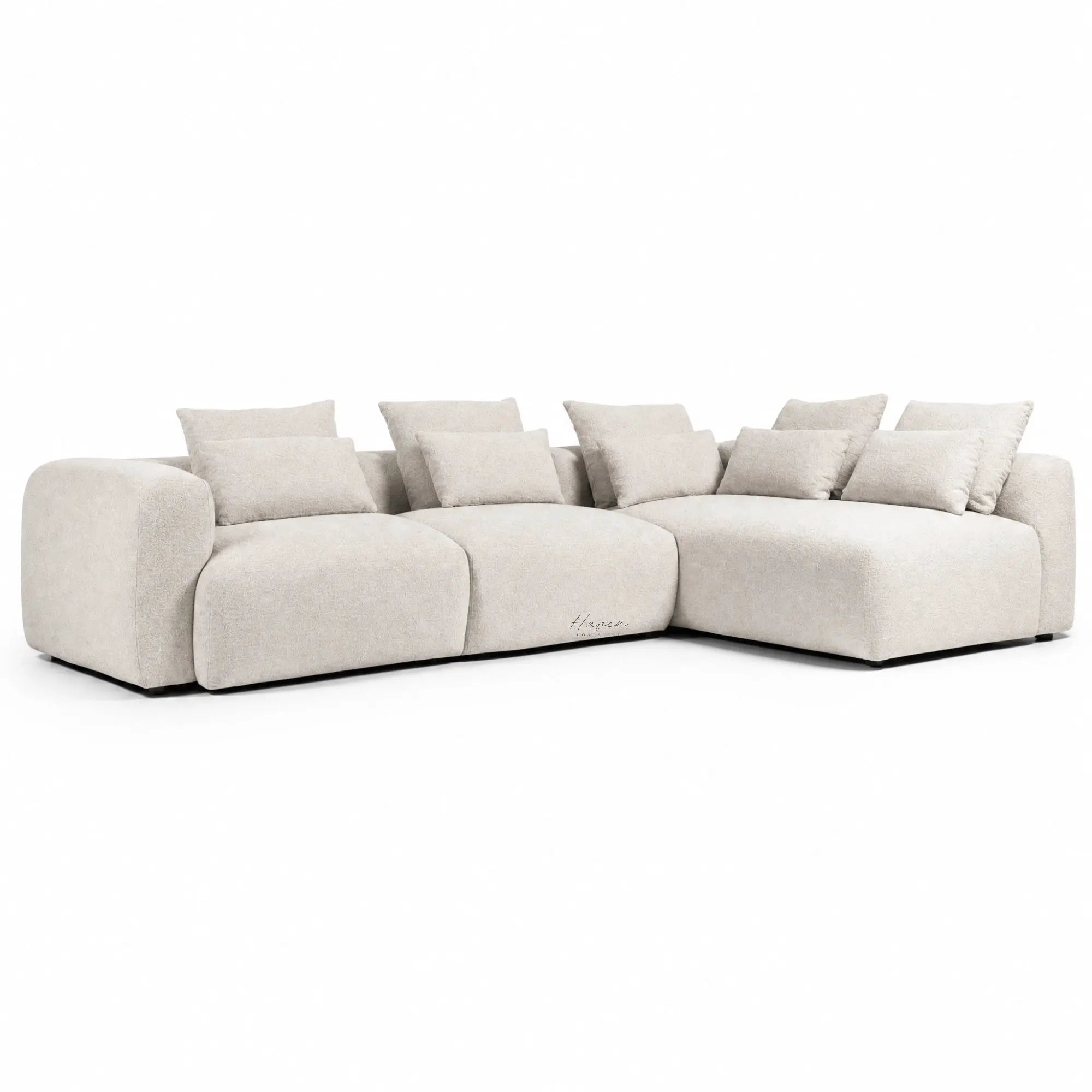 Wheat fabric sectional chaise sofa with soft sculpted curves and plush cushions for a relaxed, modern living room look.