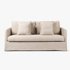 Beige Lumi slipcover sofa with soft tailored polyester fabric, generous cushioning, and matching throw pillows.