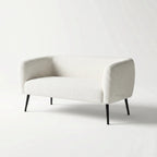 Ellie 2 Seat Sofa in soft cream polyester upholstery with slim powder-coated legs.
