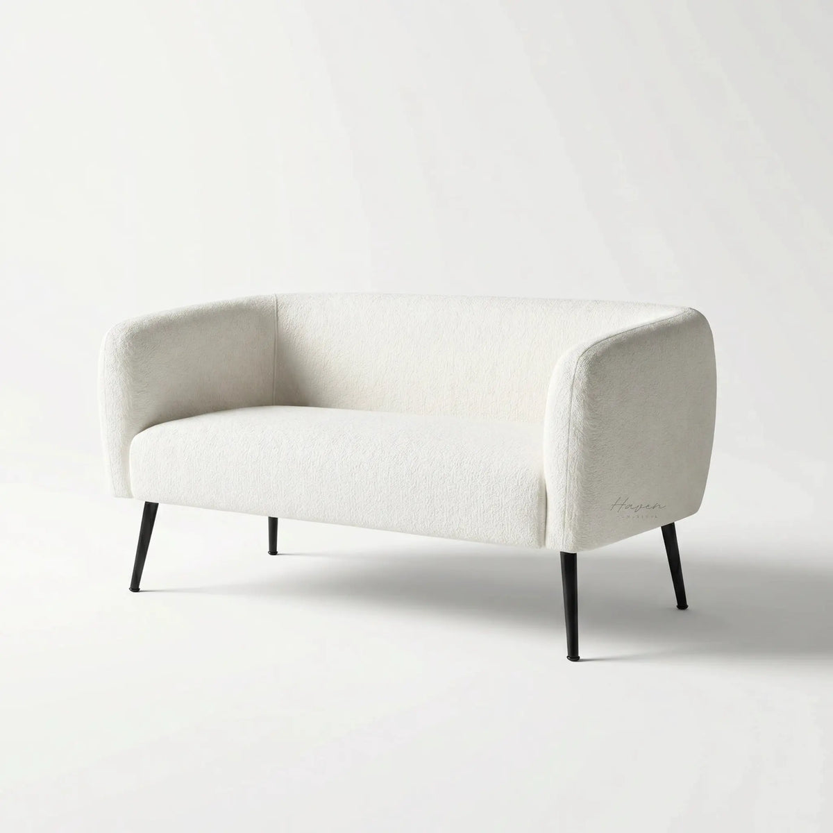 Ellie 2 Seat Sofa in soft cream polyester upholstery with slim powder-coated legs.