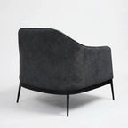 The Sydney Chair in charcoal recycled-polyester fabric with a curved cushioned silhouette for relaxed modern NZ homes.