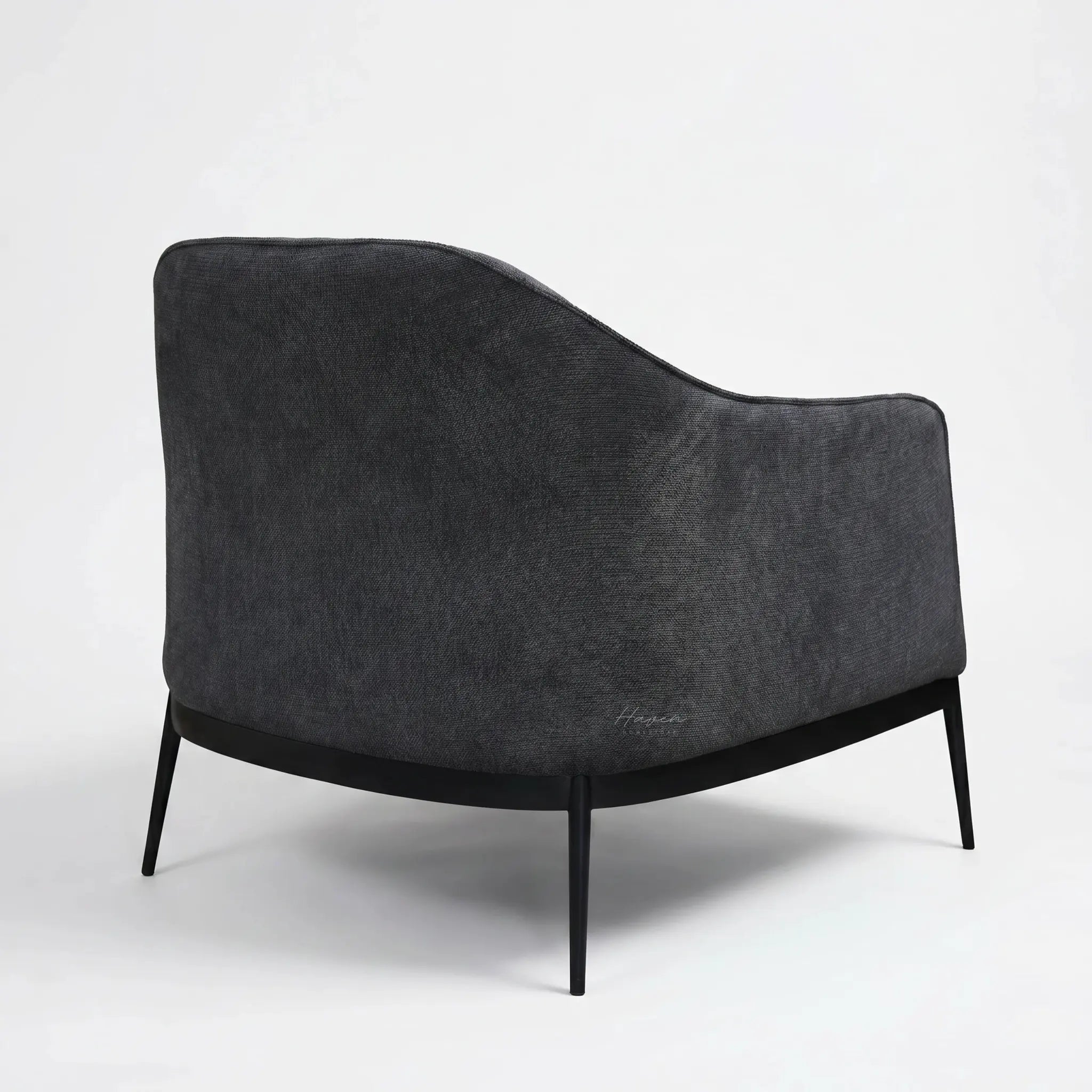 The Sydney Chair in charcoal recycled-polyester fabric with a curved cushioned silhouette for relaxed modern NZ homes.