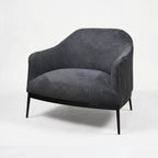 The Sydney Chair features soft textured, 100% recycled polyester upholstery, curved back, and slim black legs.