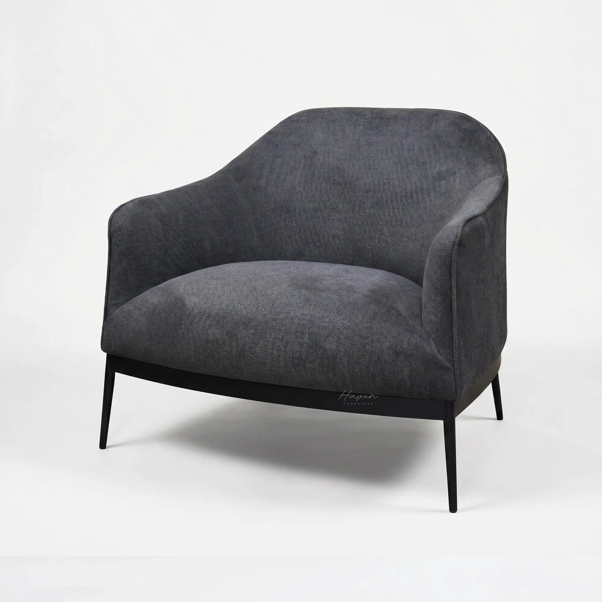 The Sydney Chair features soft textured, 100% recycled polyester upholstery, curved back, and slim black legs.