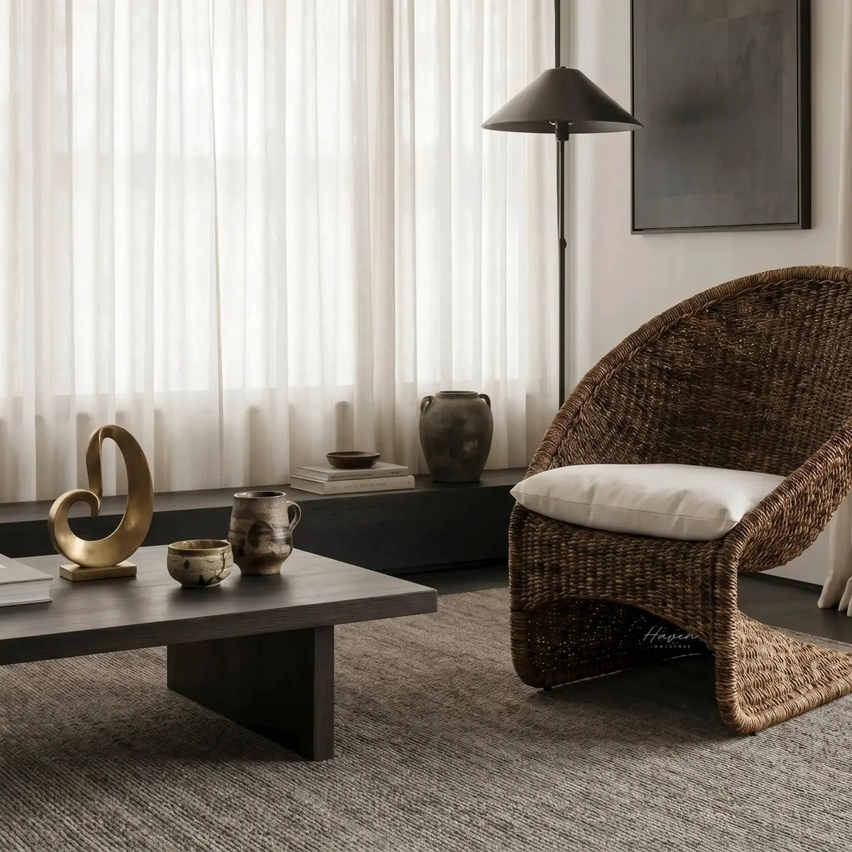 Scoop Chair with handwoven water hyacinth rope and cushioned seat and back for lounging in a serene living space.