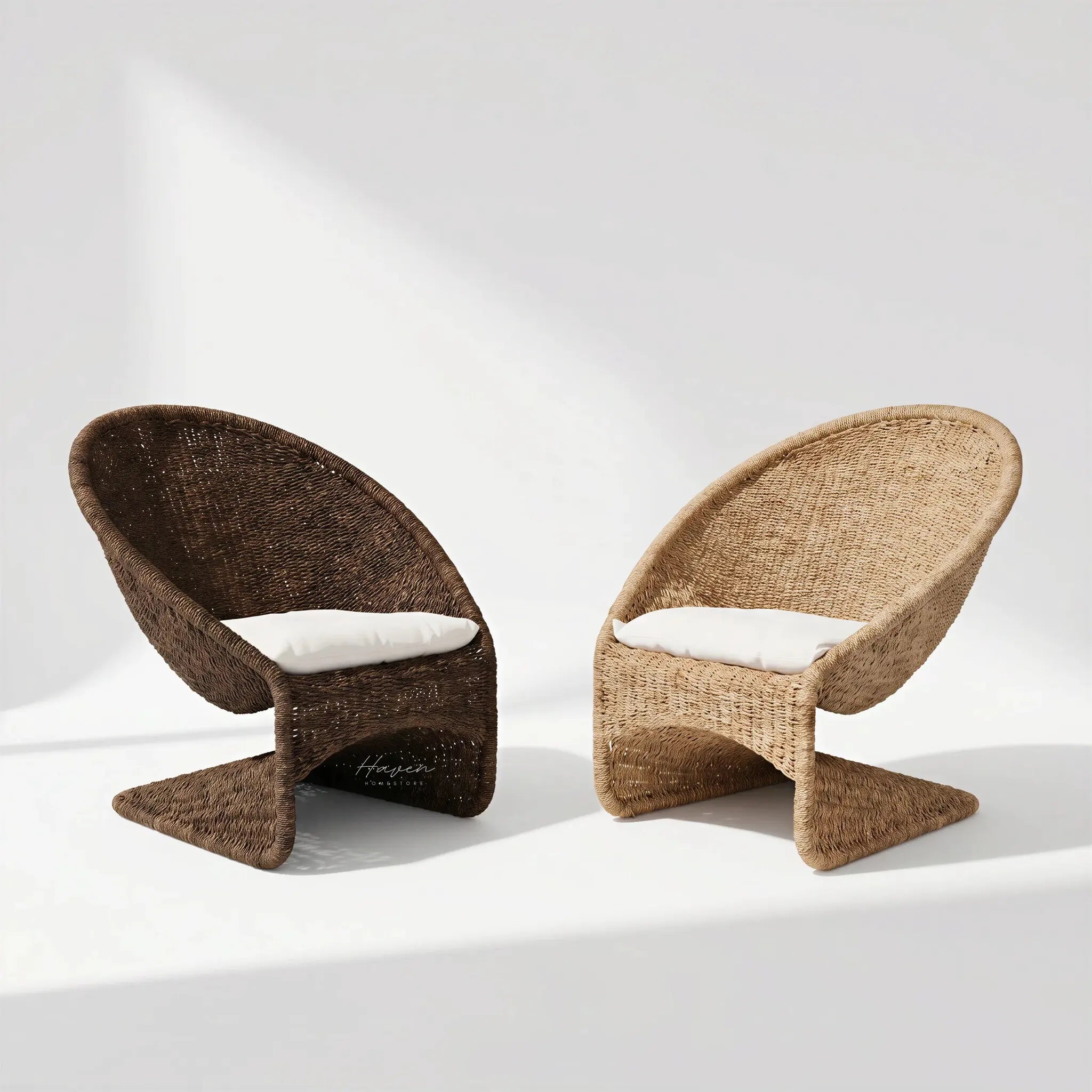 Pair of Scoop Chairs in dark brown and natural wicker with white cushions and handwoven water hyacinth rope.