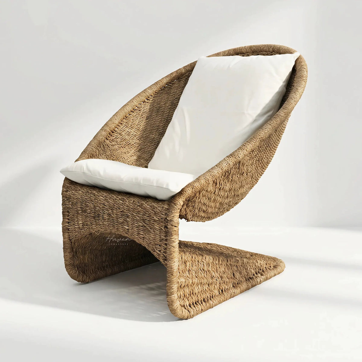 Scoop Chair with handwoven water hyacinth rope and white cushions, cozy lounge seating.