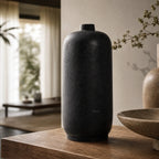 Black hand-thrown terracotta vase from the Ishi Set displayed on a wooden surface.