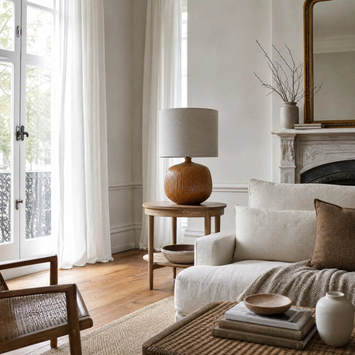 Aksel Table Lamp in Umber with ribbed ceramic base and linen shade on wood side table.